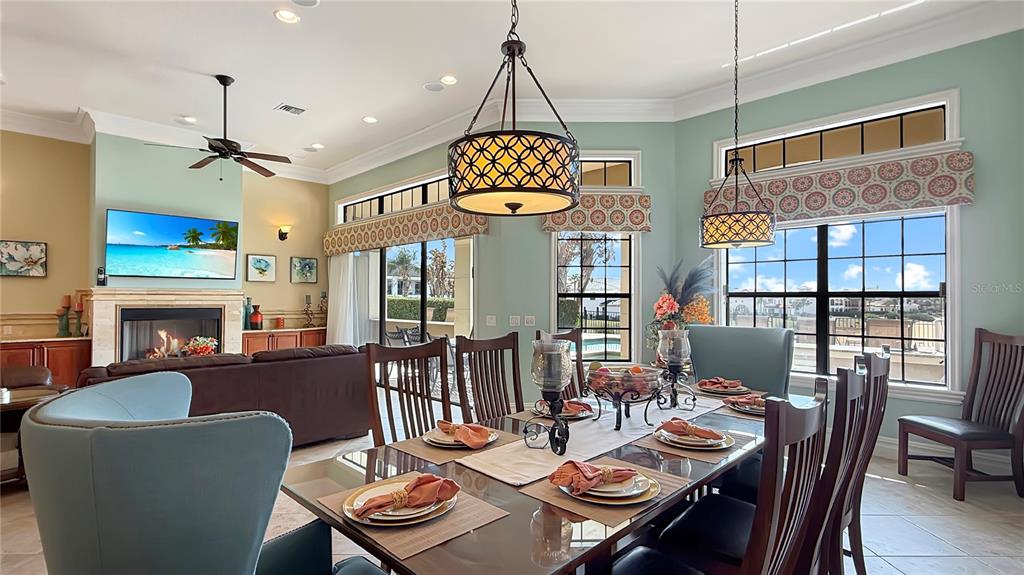 451 Muirfield Loop Reunion, FL 34747 - Photo 24 of 67 a dining room with furniture a chandelier and window