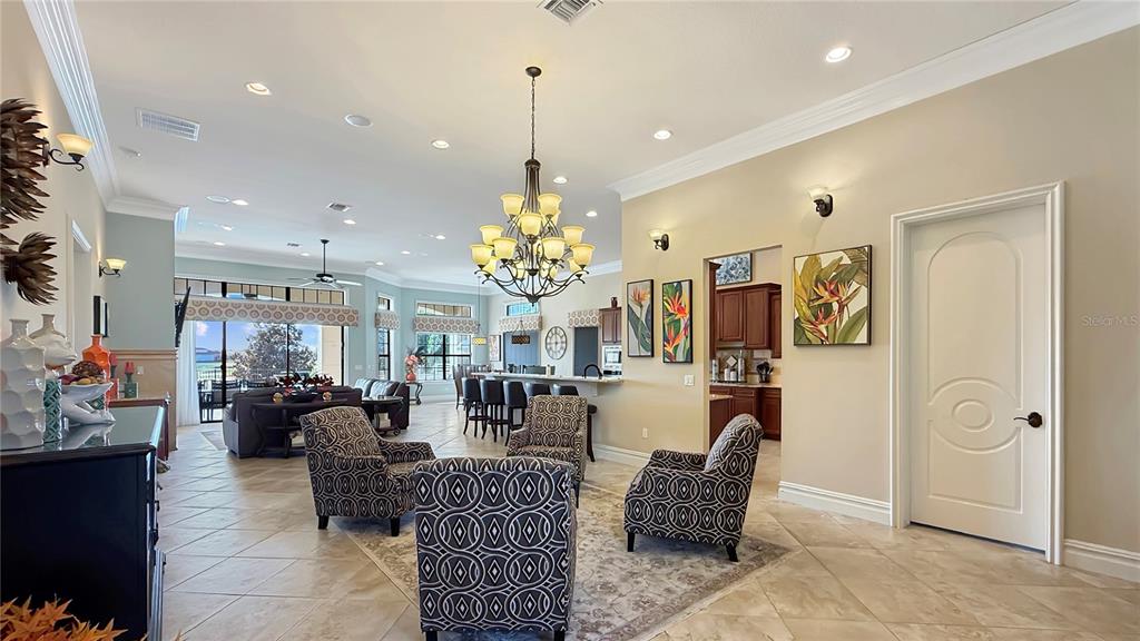 451 Muirfield Loop Reunion, FL 34747 - Photo 26 of 67 a living room with lots of furniture and chandelier
