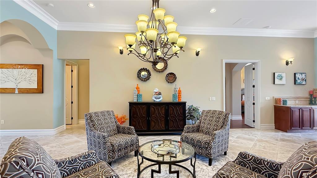 451 Muirfield Loop Reunion, FL 34747 - Photo 27 of 67 a living room with furniture chandelier and a chandelier