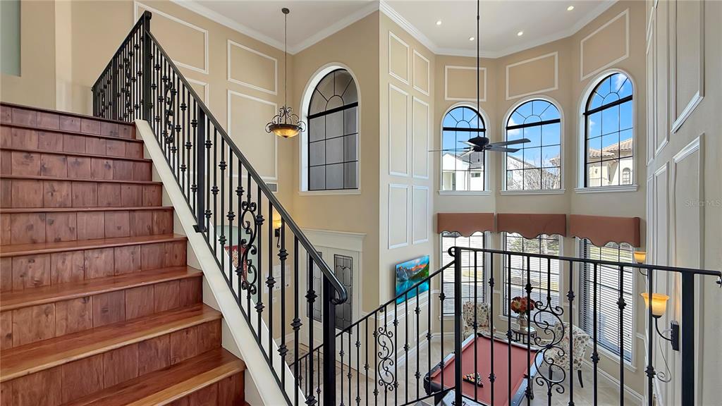 451 Muirfield Loop Reunion, FL 34747 - Photo 34 of 67 a view of staircase with railing and a chandelier