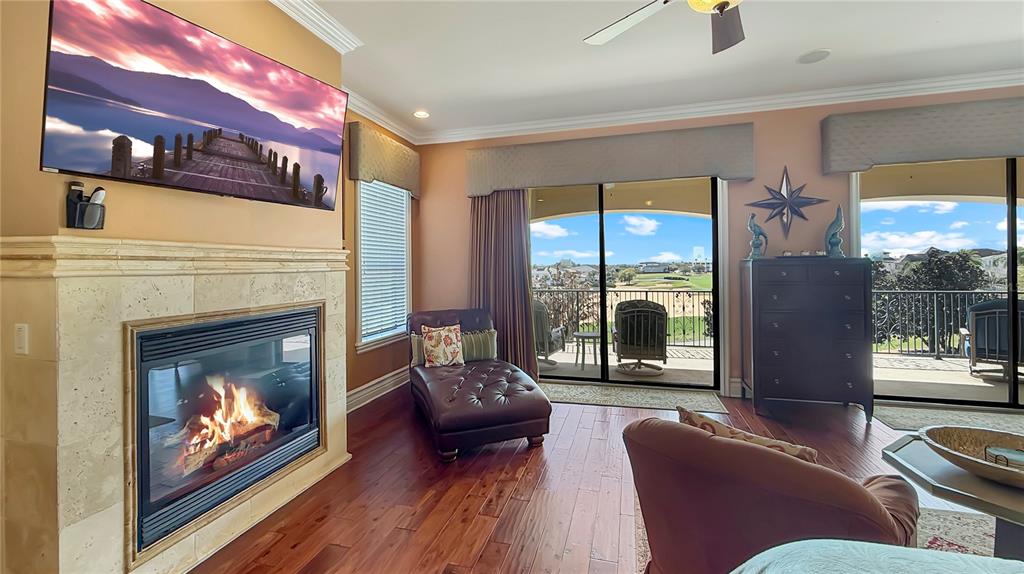 451 Muirfield Loop Reunion, FL 34747 - Photo 41 of 67 a living room with furniture a fireplace and a floor to ceiling window