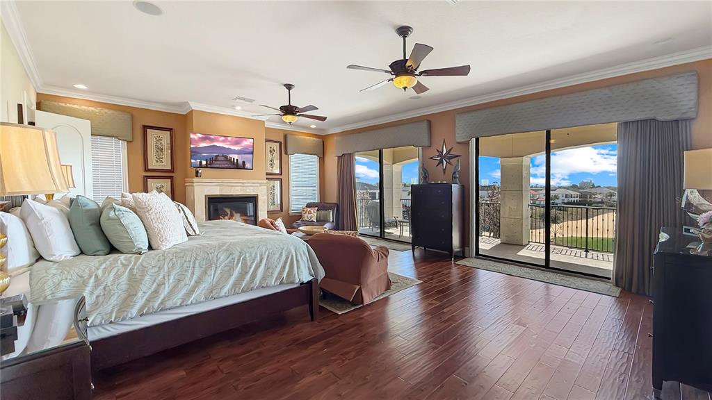 451 Muirfield Loop Reunion, FL 34747 - Photo 42 of 67 a spacious bedroom with a balcony a bed and glass walk in closet