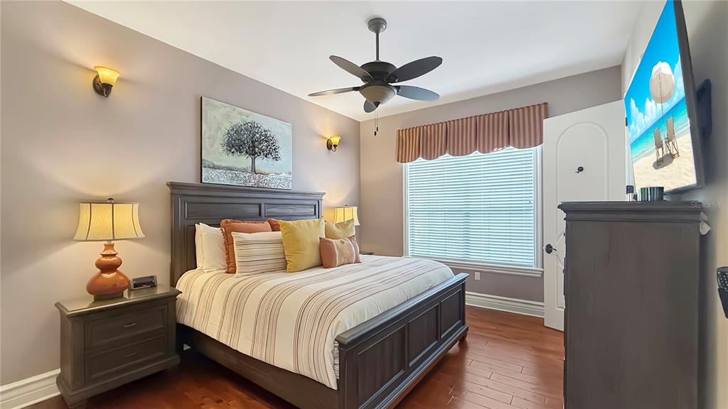 451 Muirfield Loop Reunion, FL 34747 - Photo 48 of 67 a bedroom with a bed and a chandelier