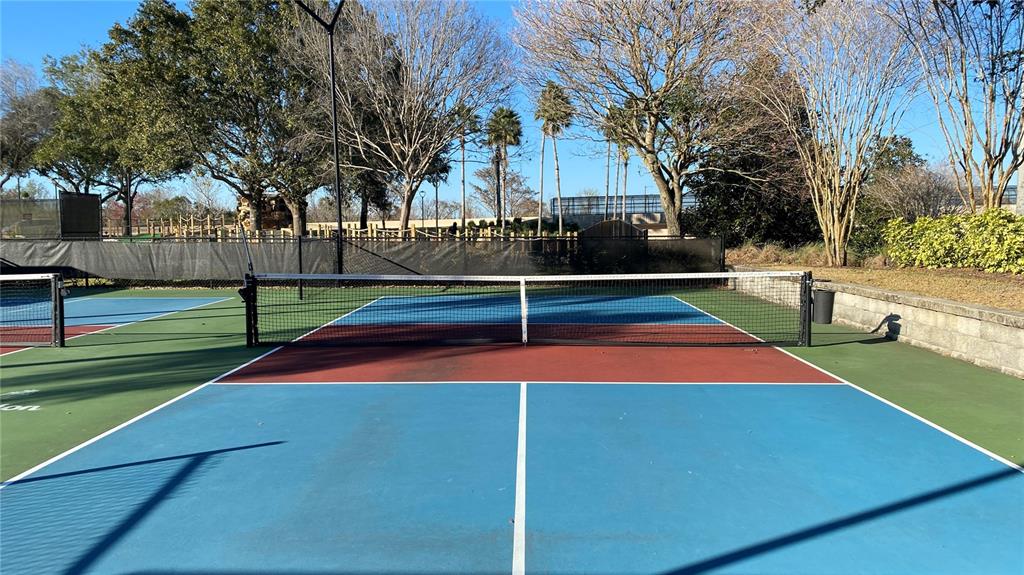 451 Muirfield Loop Reunion, FL 34747 - Photo 67 of 67 a tennis court that has the trees in the background