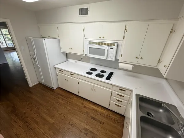 a kitchen with cabinets and a stove