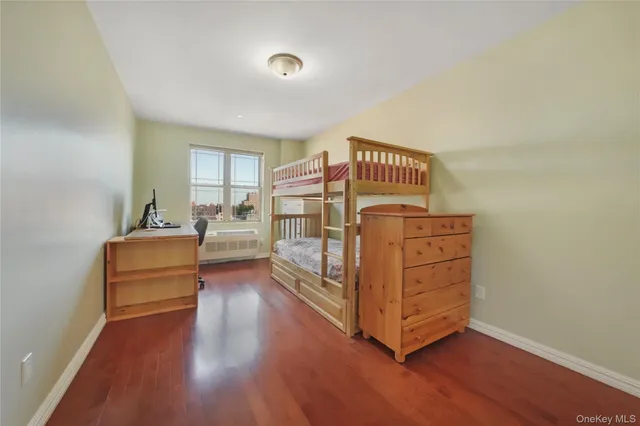 a bedroom with furniture and wooden floor