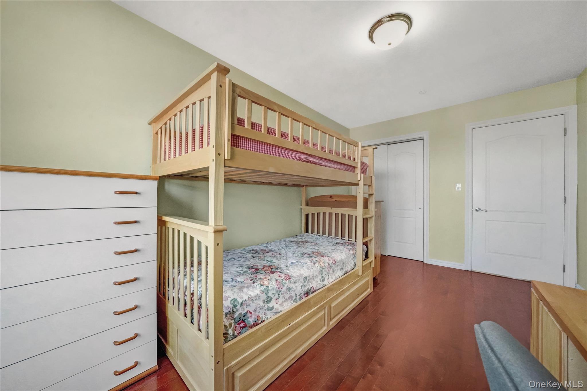 40-40 75th Street, Unit 7C Queens, NY 11373 - Photo 12 of 33 Bedroom with dark wood-style flooring and a closet