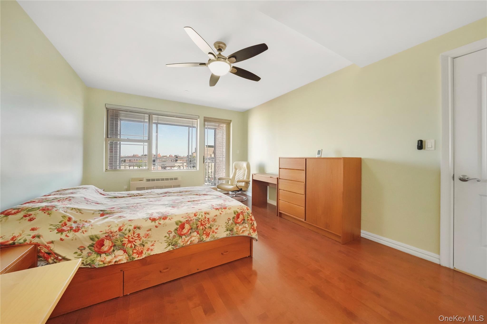 40-40 75th Street, Unit 7C Queens, NY 11373 - Photo 15 of 33 Bedroom with wood finished floors, ceiling fan, and radiator heating unit