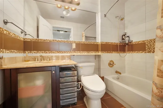 a bathroom with a sink a toilet and bathtub