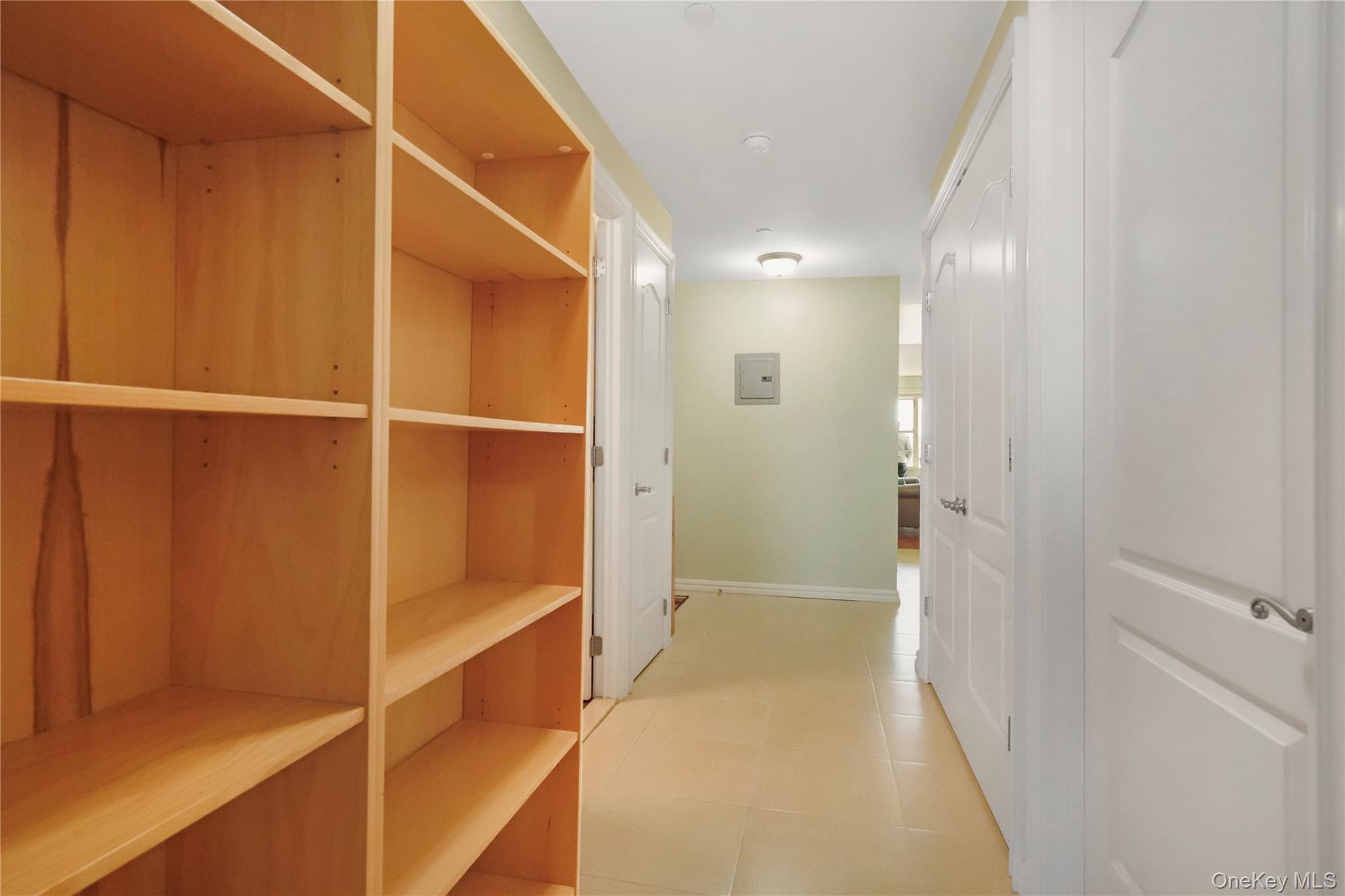 40-40 75th Street, Unit 7C Queens, NY 11373 - Photo 21 of 33 Corridor with light tile patterned flooring and baseboards