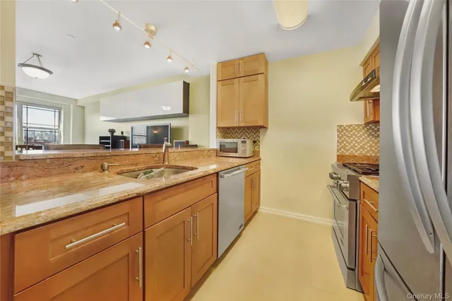 a bathroom with a sink double vanity granite and a bathtub