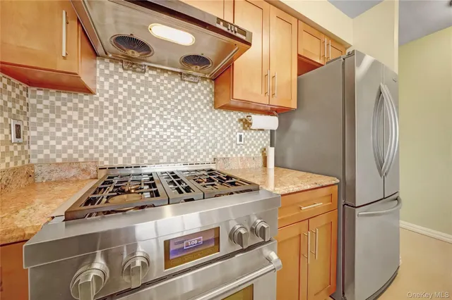 a white stove top oven sitting inside of a kitchen