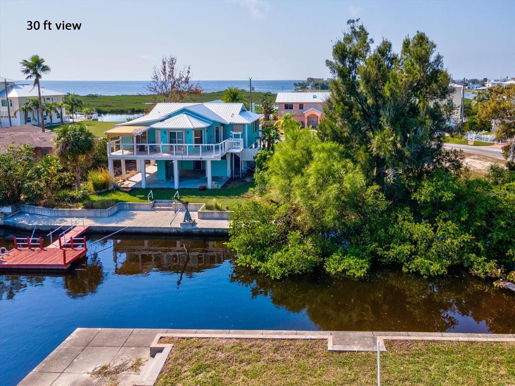 4230 Orchid Drive Hernando Beach, FL 34607 - Photo 14 of 36 a view of a big house with wooden floor