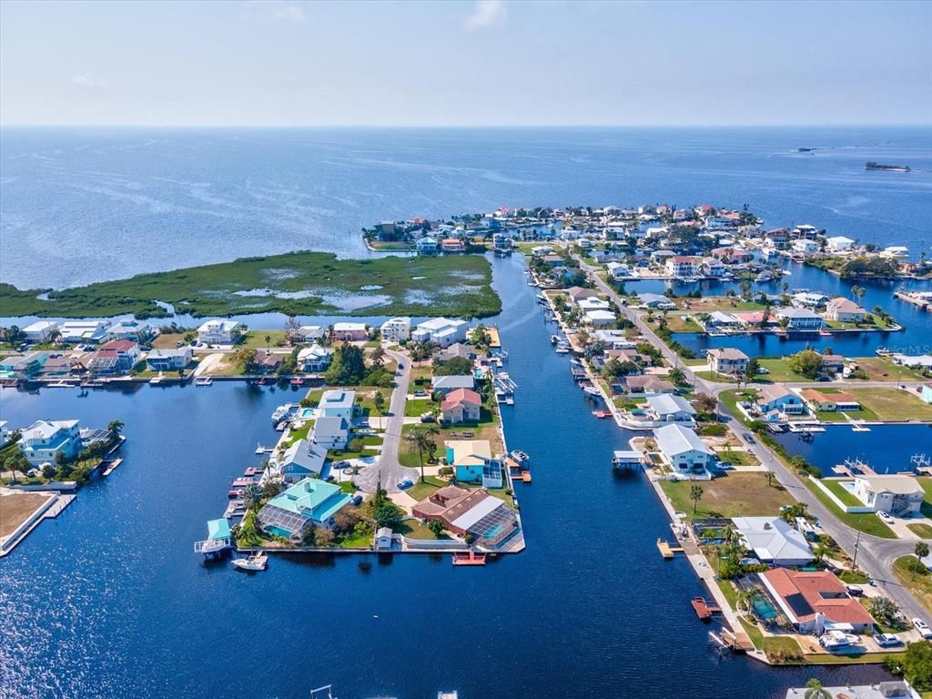4230 Orchid Drive Hernando Beach, FL 34607 - Photo 18 of 36 an aerial view of a city with lots of residential buildings ocean and mountain view in back
