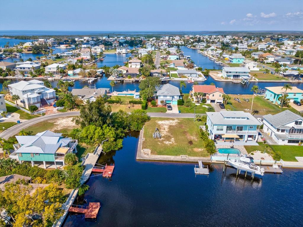 4230 Orchid Drive Hernando Beach, FL 34607 - Photo 22 of 36 an aerial view of residential houses with outdoor space and swimming pool