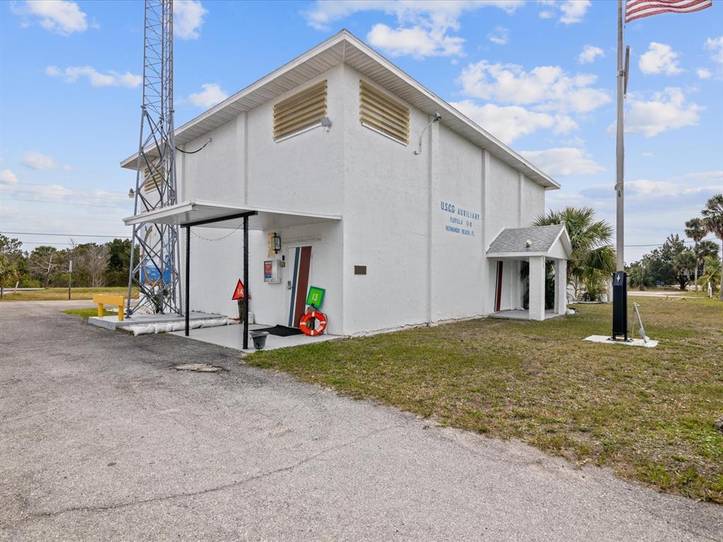 4230 Orchid Drive Hernando Beach, FL 34607 - Photo 28 of 36 a view of a house with backyard and a garage