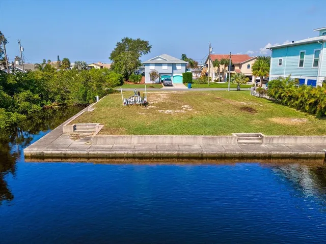 an aerial view of a house with swimming pool patio and outdoor seating