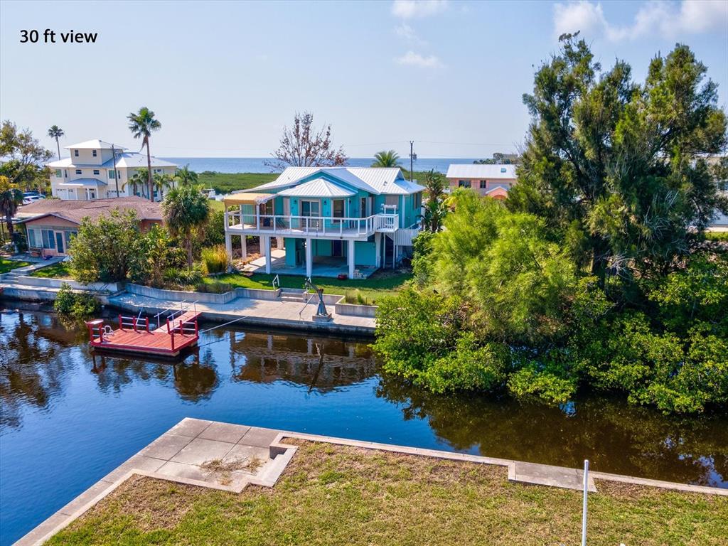 4230 Orchid Drive Hernando Beach, FL 34607 - Photo 9 of 36 a front view of house with yard swimming pool and outdoor seating