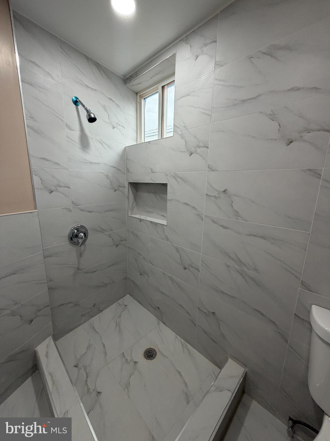 3019 D Street Philadelphia, PA 19134 - Photo 14 of 19 Sleek marble shower with modern fixtures.
