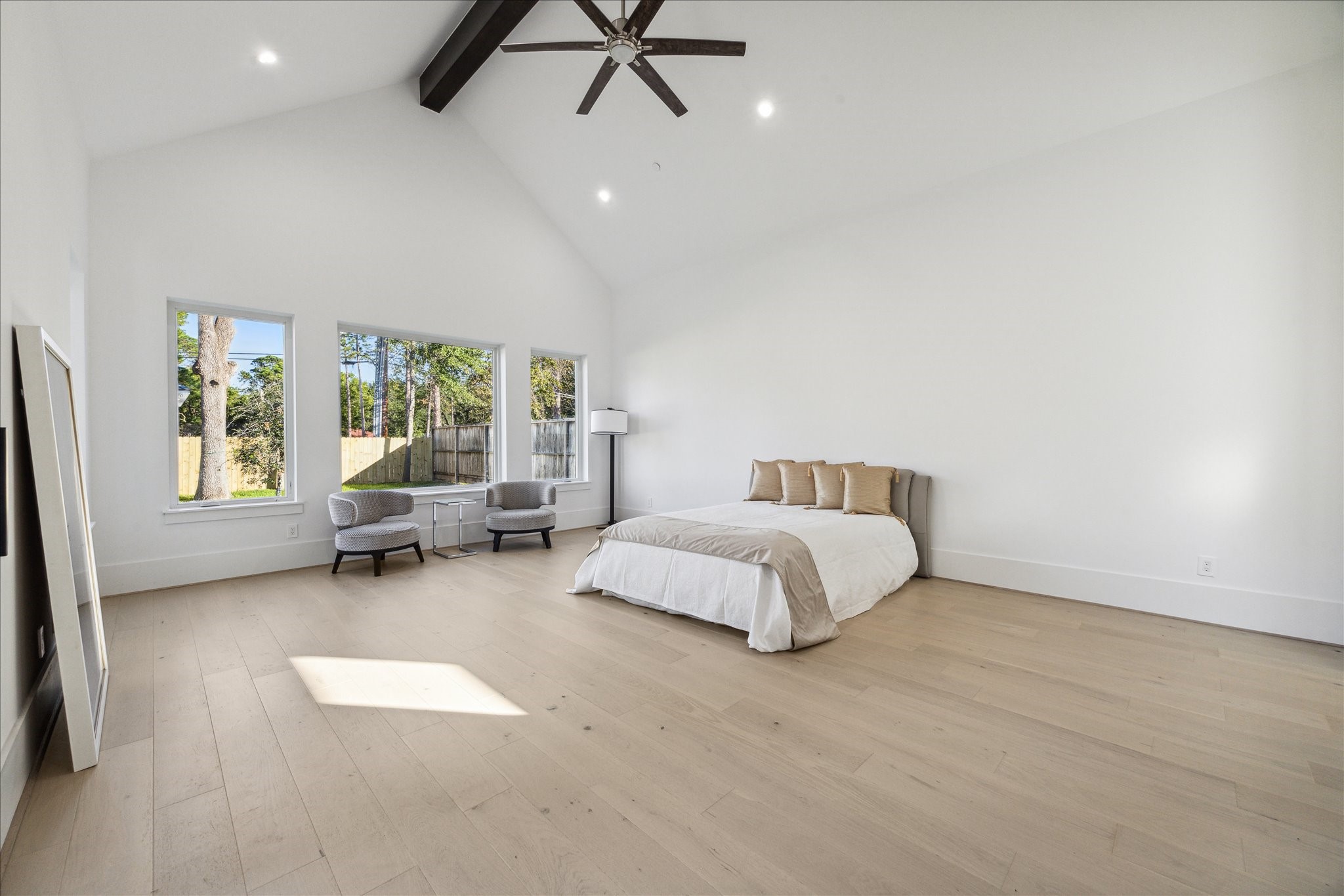 534 Lanecrest Lane Houston, TX 77024 - Photo 22 of 49 a spacious bedroom with a bed a couch and a window