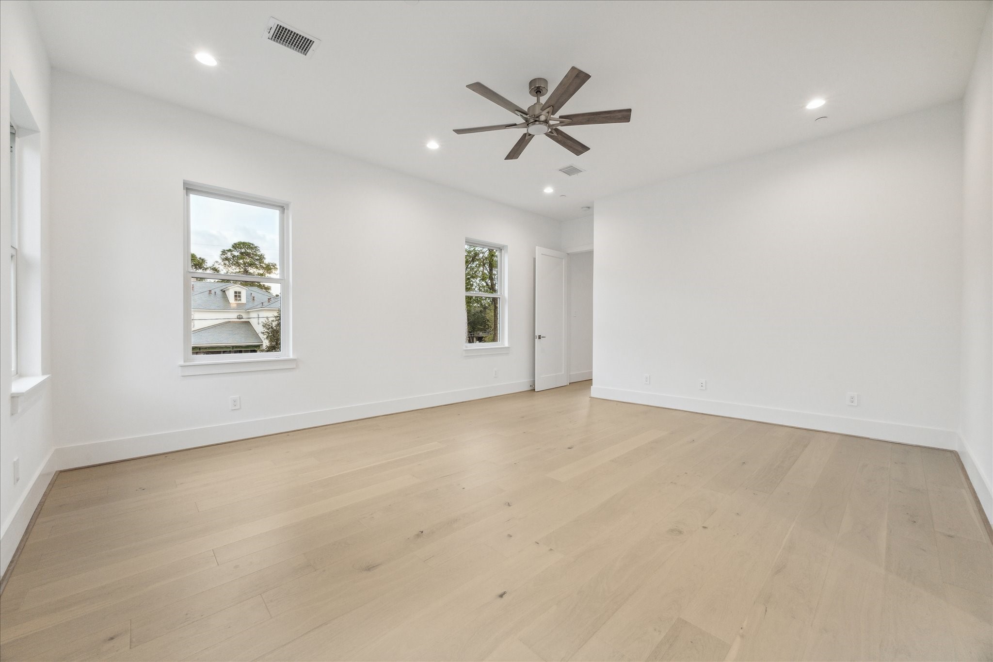 534 Lanecrest Lane Houston, TX 77024 - Photo 31 of 49 an empty room with windows and fan