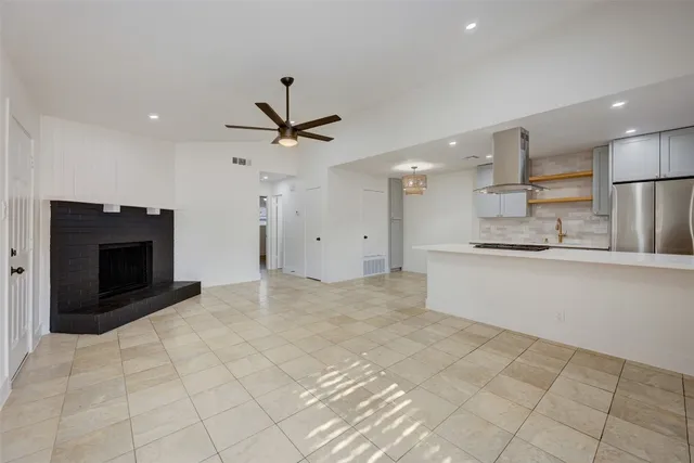 a view of kitchen with furniture and stainless steel appliances