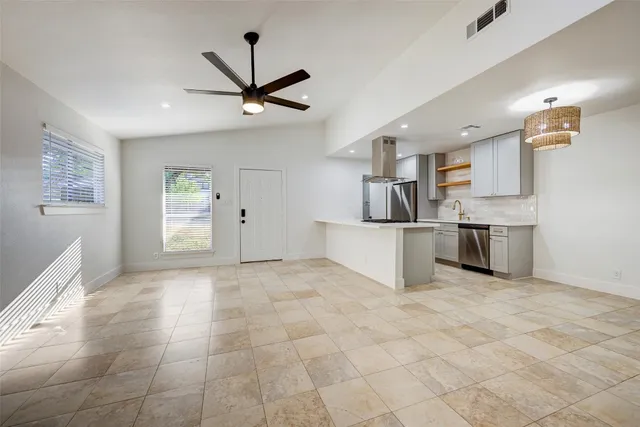 a view of a kitchen with furniture and a ceiling fan