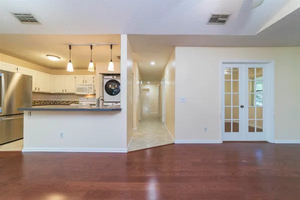 a kitchen with white cabinets and white appliances