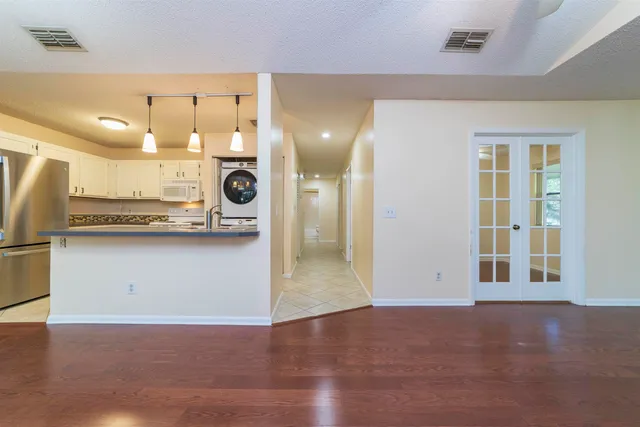 a kitchen with white cabinets and white appliances
