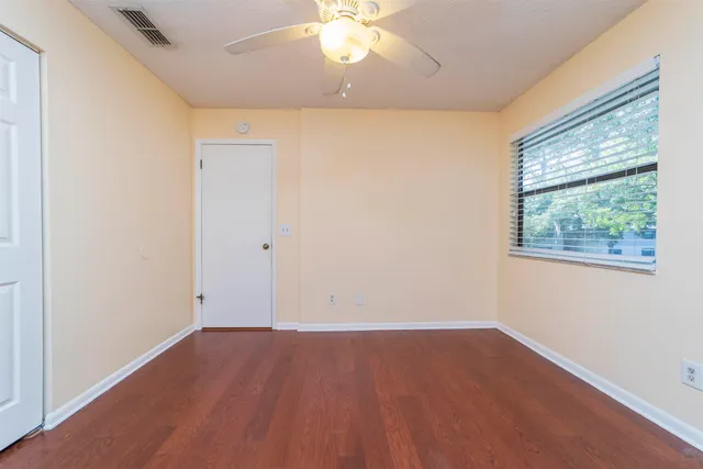 wooden floor in an empty room with a window
