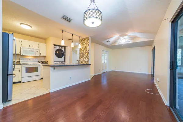 a view of kitchen with stove and microwave