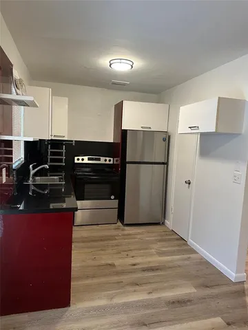 a kitchen with a refrigerator and a stove