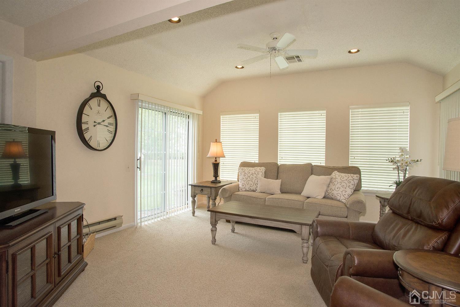 793 Pompton Road, Unit A Monroe Township, NJ 08831 - Photo 11 of 15 a living room with furniture a large window and a clock