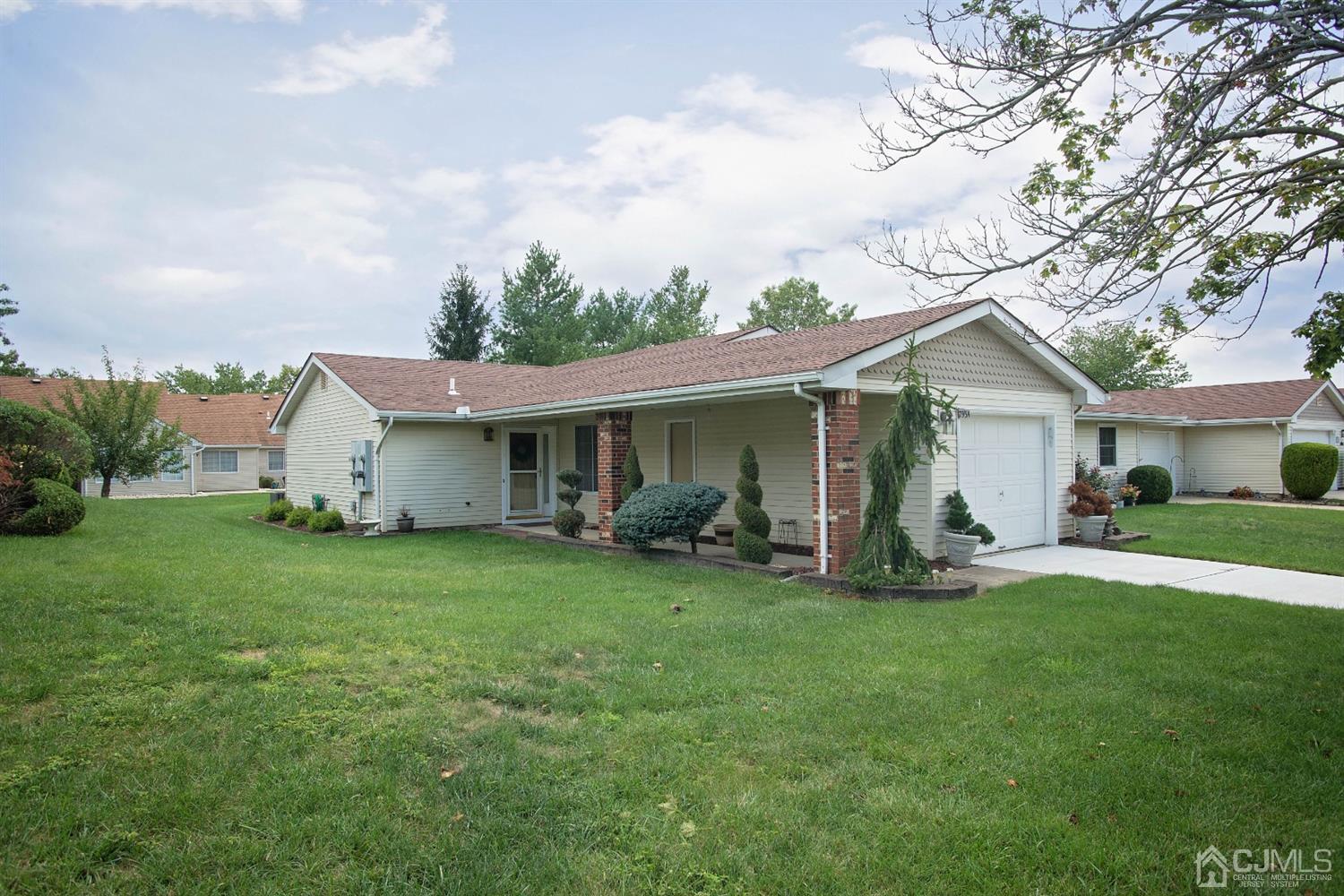 793 Pompton Road, Unit A Monroe Township, NJ 08831 - Photo 14 of 15 a front view of a house with a garden and trees