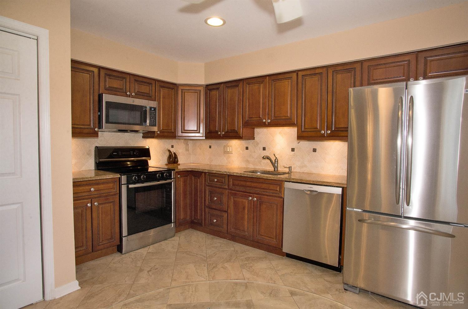 793 Pompton Road, Unit A Monroe Township, NJ 08831 - Photo 3 of 15 a kitchen with granite countertop a refrigerator stove top oven and sink