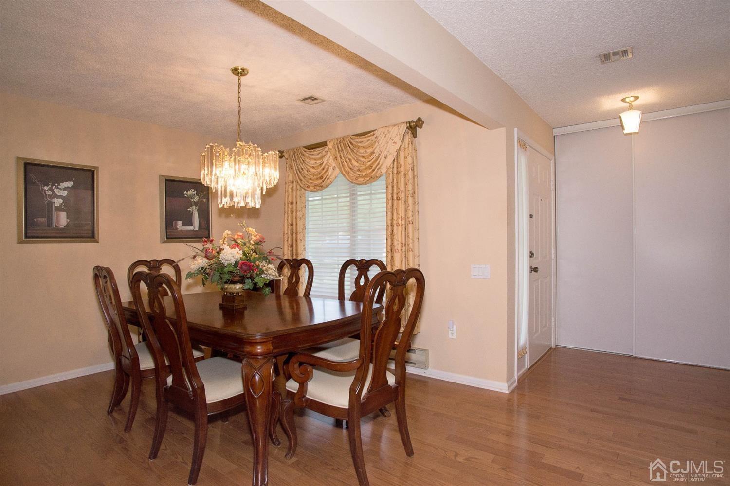 793 Pompton Road, Unit A Monroe Township, NJ 08831 - Photo 7 of 15 a view of a dining room with furniture window and wooden floor