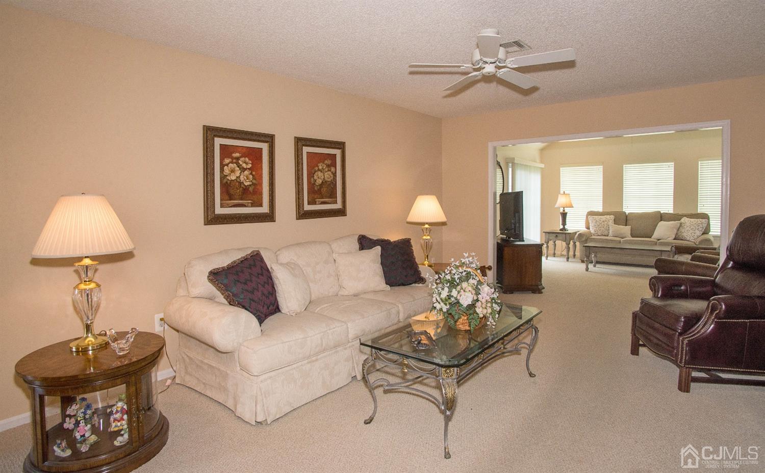 793 Pompton Road, Unit A Monroe Township, NJ 08831 - Photo 9 of 15 a living room with furniture and a chandelier