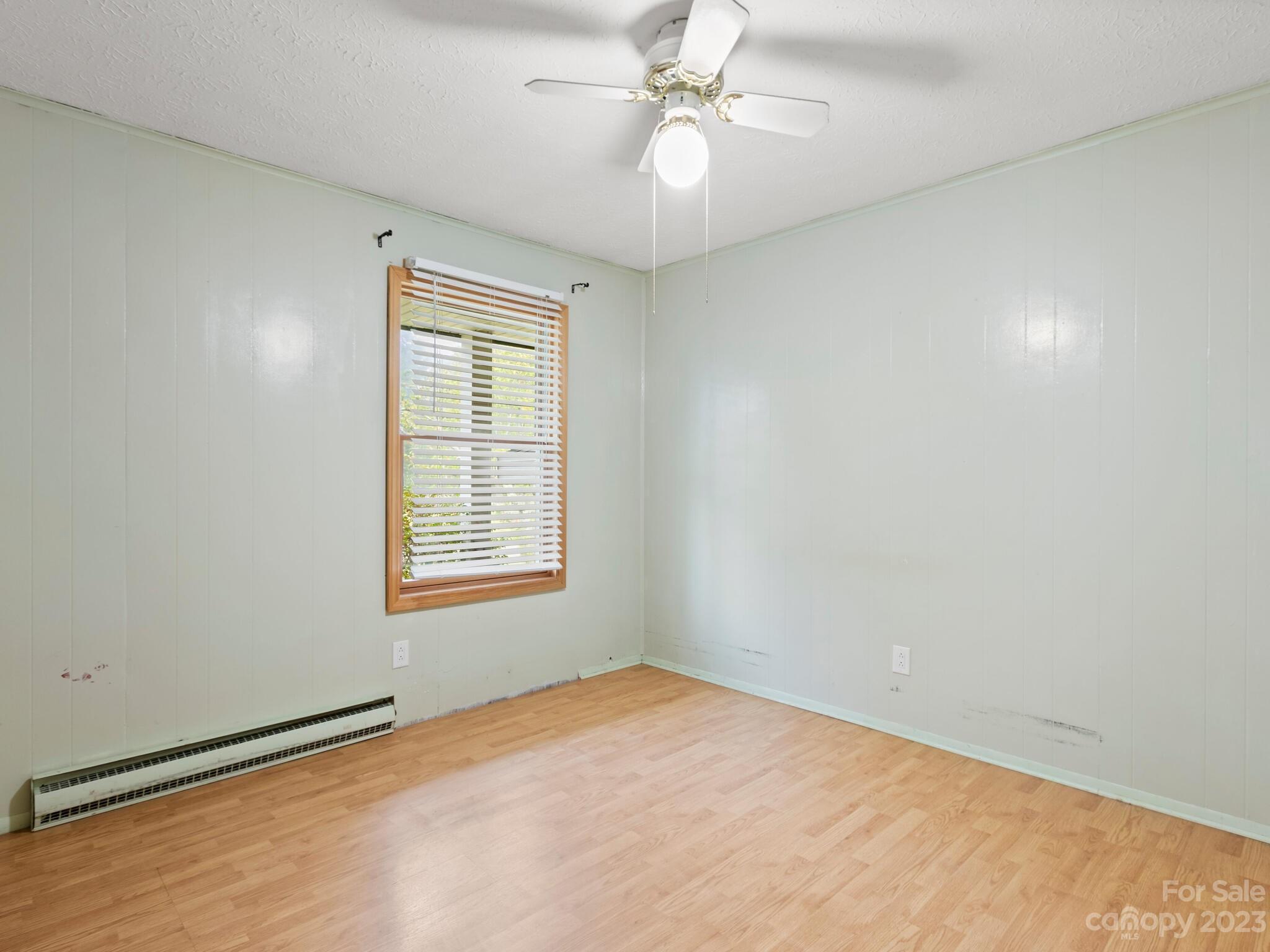 98 Pinecrest Drive Alexander, NC 28701 - Photo 13 of 32 an empty room with windows and fan