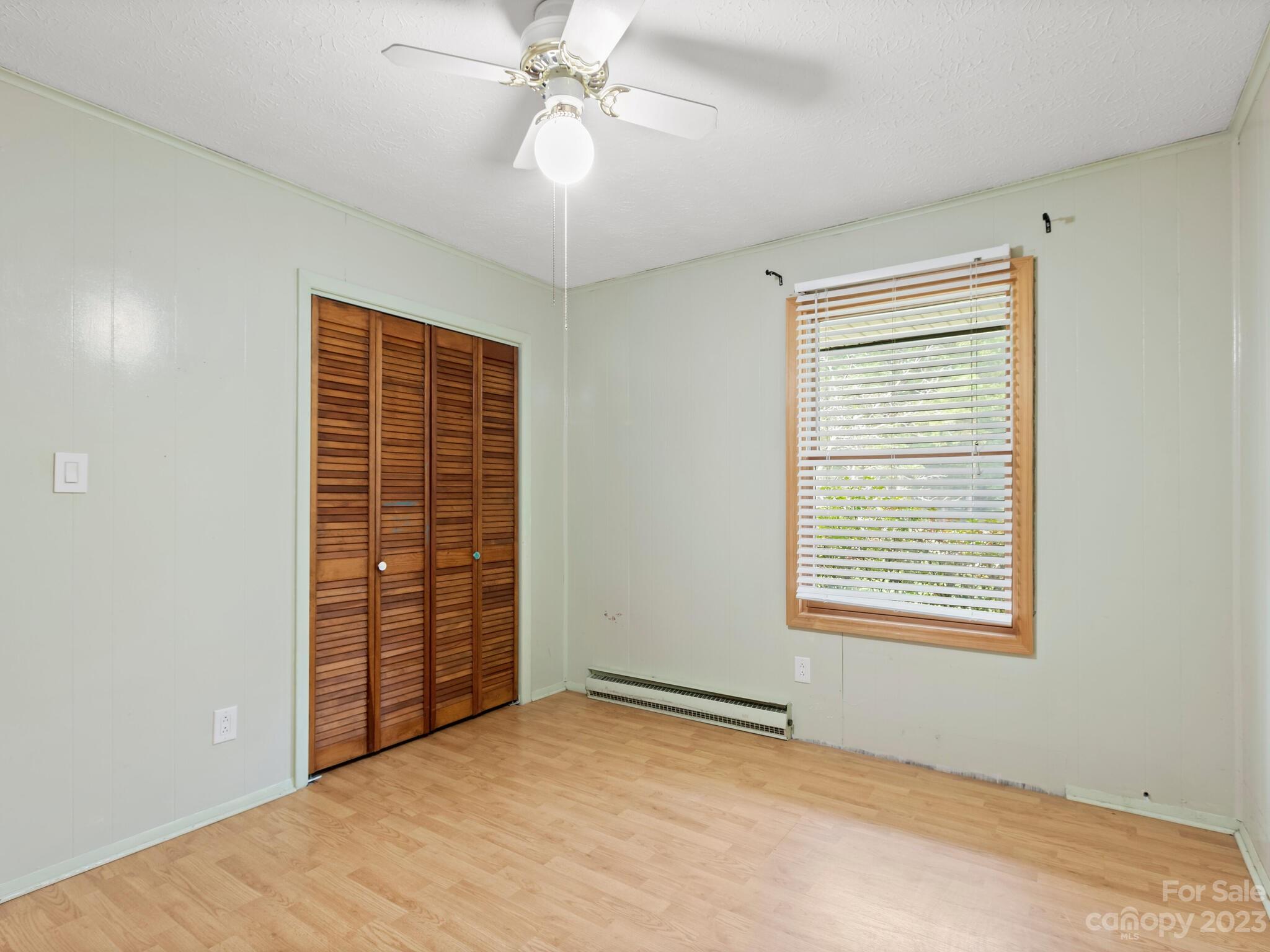 98 Pinecrest Drive Alexander, NC 28701 - Photo 14 of 32 an empty room with windows and fan