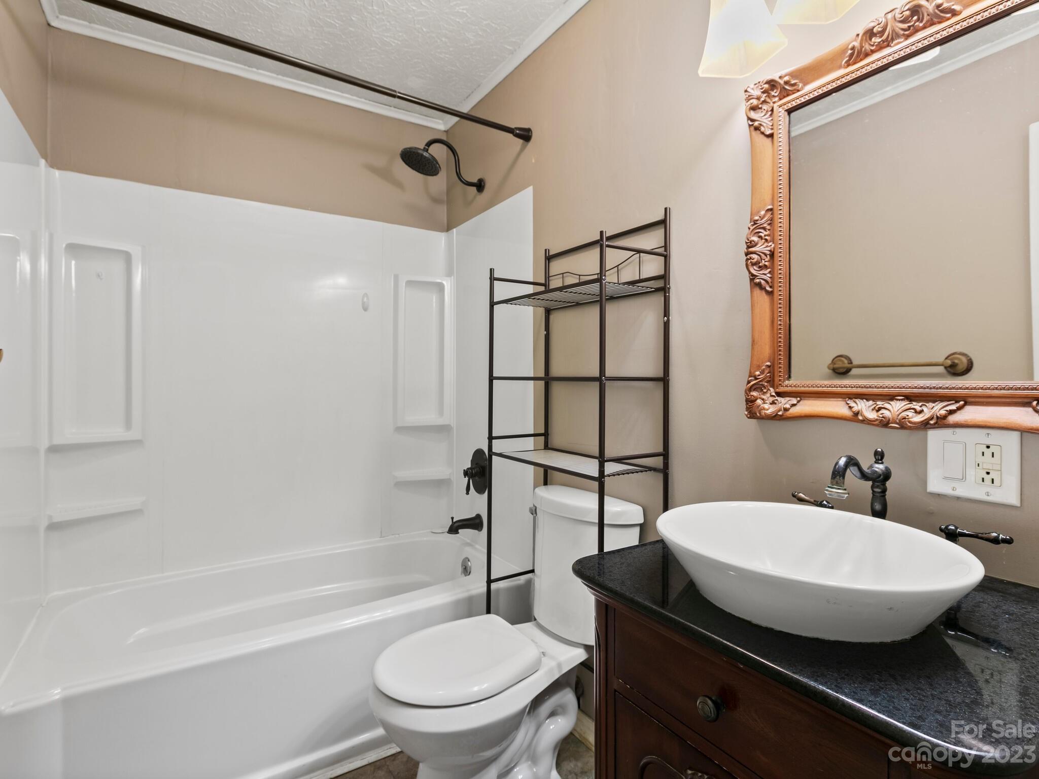 98 Pinecrest Drive Alexander, NC 28701 - Photo 15 of 32 a bathroom with a toilet a sink and bathtub