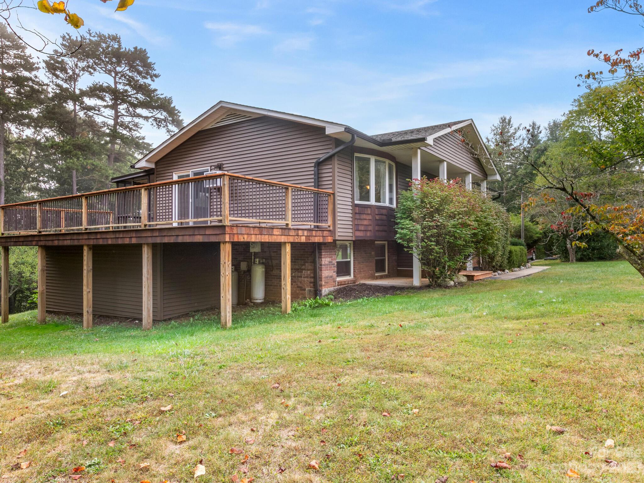 98 Pinecrest Drive Alexander, NC 28701 - Photo 2 of 32 a view of a house with a yard and plants