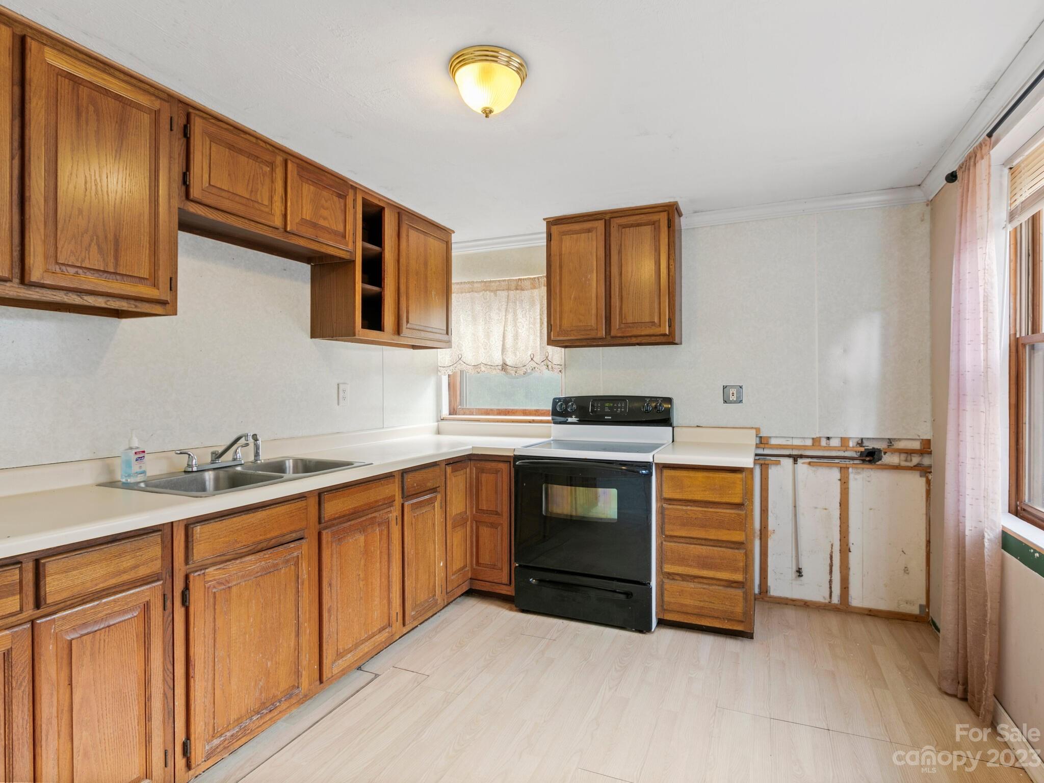 98 Pinecrest Drive Alexander, NC 28701 - Photo 24 of 32 a kitchen with stainless steel appliances granite countertop a sink stove and cabinets