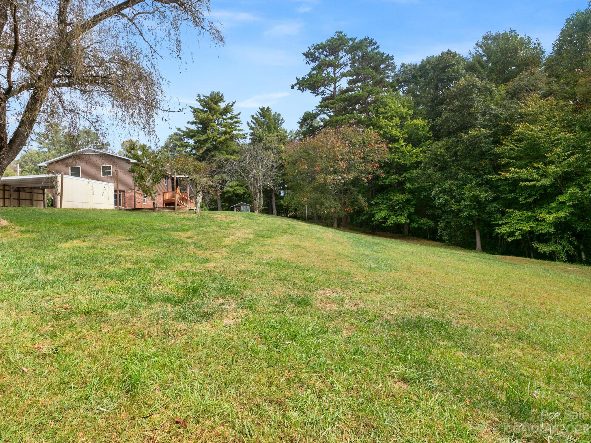 98 Pinecrest Drive Alexander, NC 28701 - Photo 31 of 32 a view of a big yard with a house in the background
