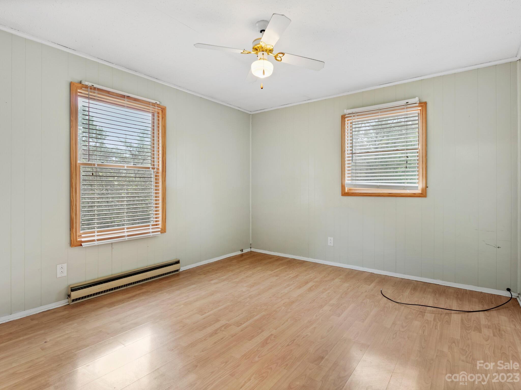 98 Pinecrest Drive Alexander, NC 28701 - Photo 10 of 32 a view of an empty room with window and wooden floor