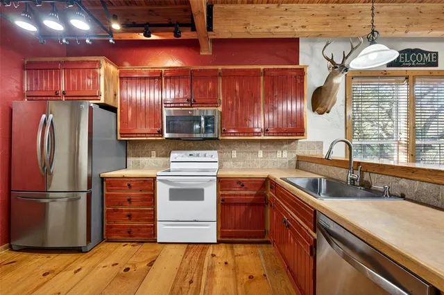 a kitchen with a sink stove and microwave