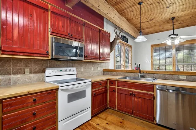a kitchen with stainless steel appliances granite countertop a stove a sink and dishwasher