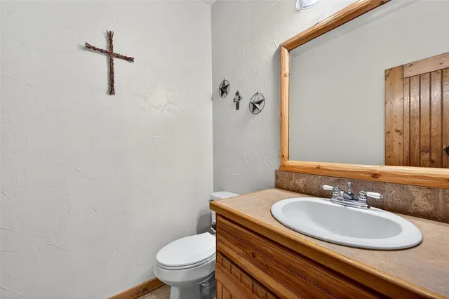 a bedroom with a bed and a flat tv screen on dresser
