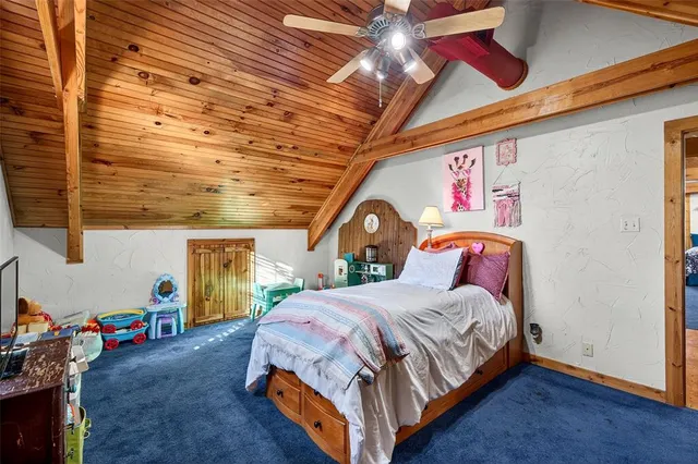 a bed sitting in a bedroom next to a window