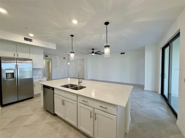 a kitchen with a sink stove and refrigerator