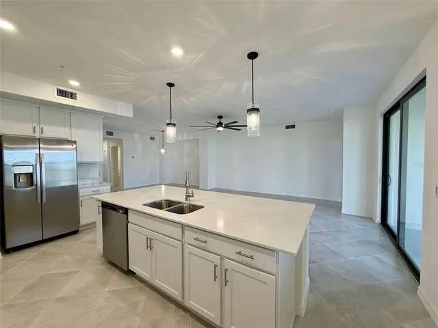 a kitchen with a sink stove and refrigerator